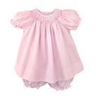Pink baby dress with ruffled sleeves on a white background