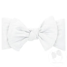 A white nylon headband with a bowtie attachment, displayed against a white background.