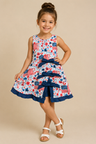 Young girl wearing a dress with American flag pattern on a beige background