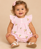 Infant girl wearing a pink seersucker bubble with mini mallard ducks as a pattern. 