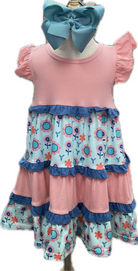 Children's outfit with pink top and floral shorts on a mannequin.