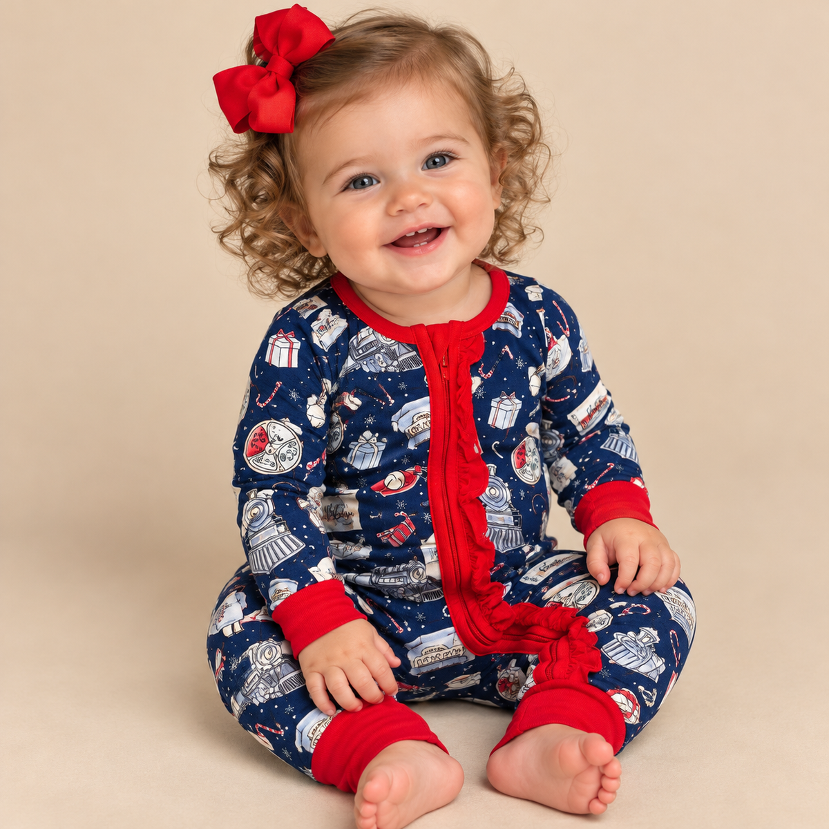 Baby girl in a zip up polar express lounge wear set.