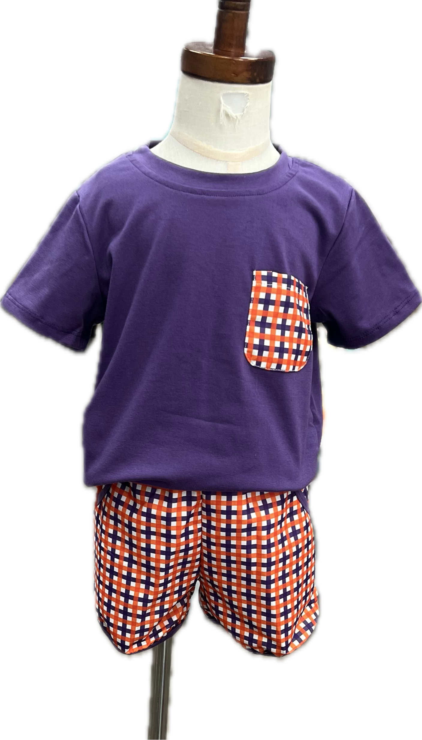 Purple t-shirt with a pocket and checkered shorts on a mannequin against a white background