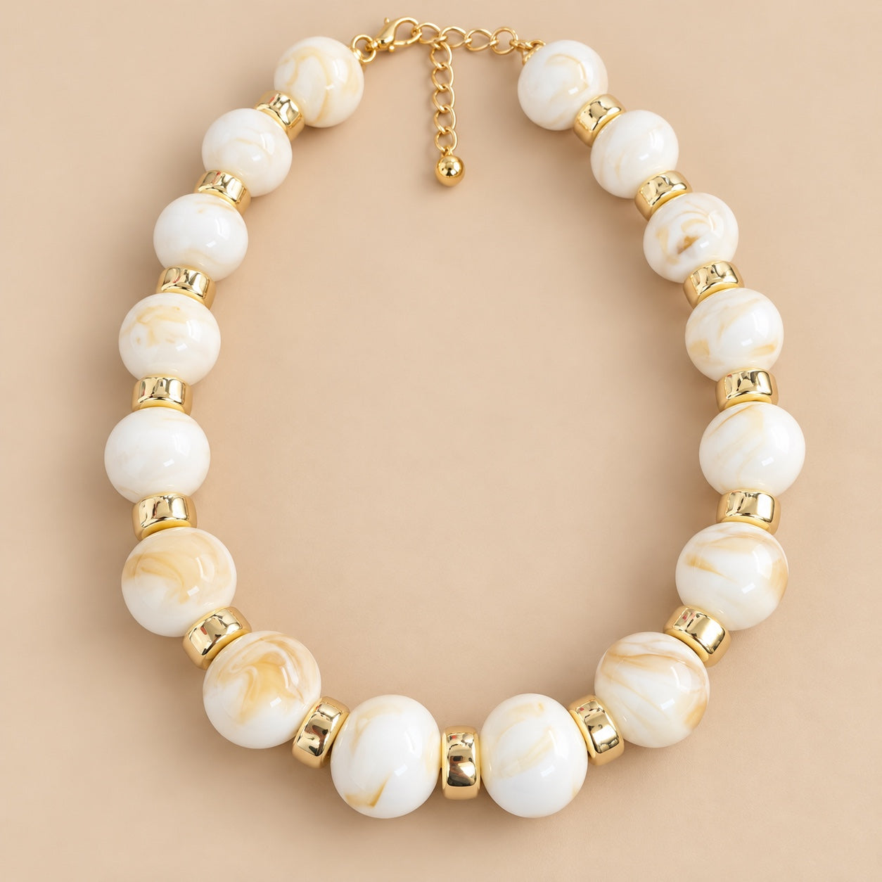 Ivory Marble Gold Bead Necklace is a women's ivory beaded statement necklace with gold-tone spacers.
