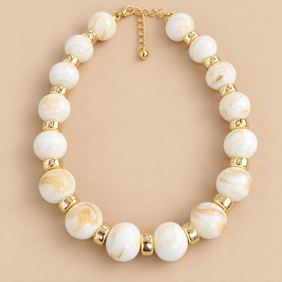 Ivory Marble Gold Bead Necklace is a women's ivory beaded statement necklace with gold-tone spacers.
