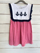 A red and white checkered dress with navy anchor appliques and a bubble bonnet.