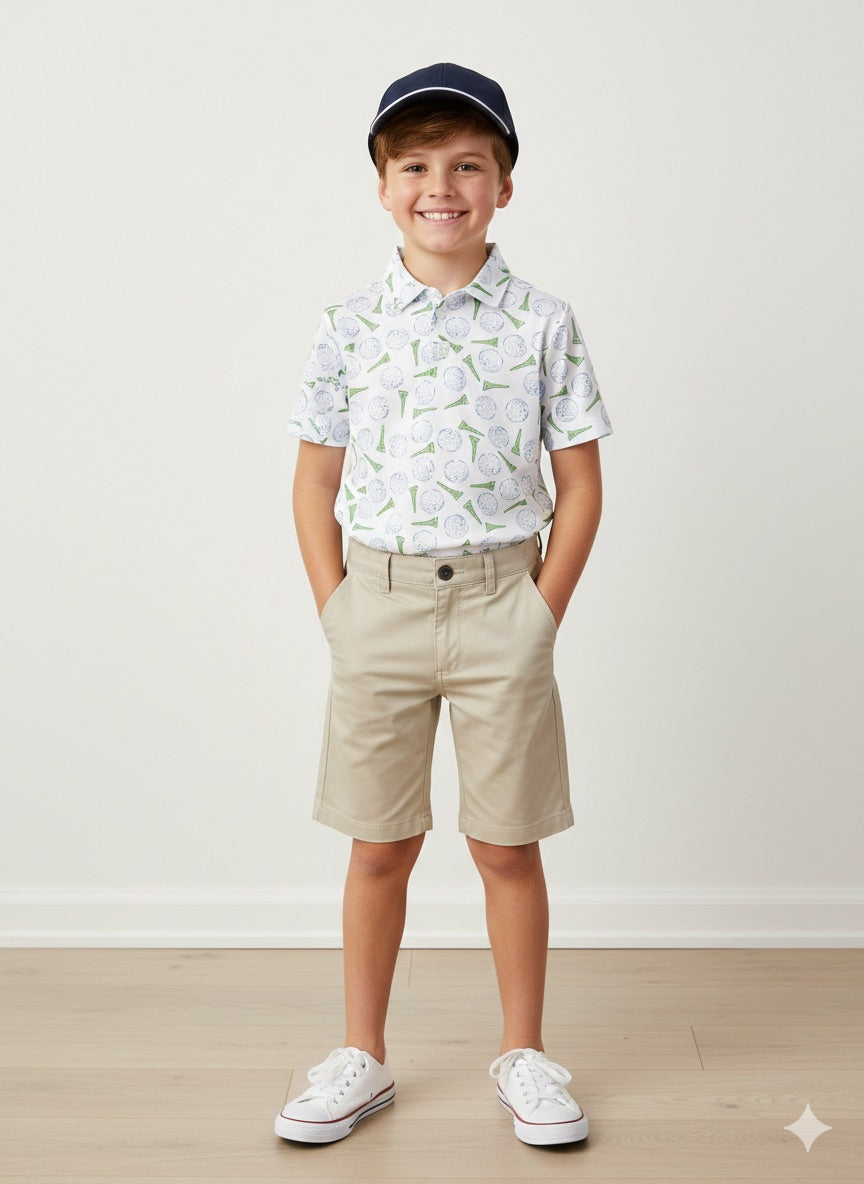 Boy wearing golf themed short sleeve polo with khaki shorts. 