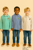 Three boys wearing striped long sleeve Christmas polos. 
