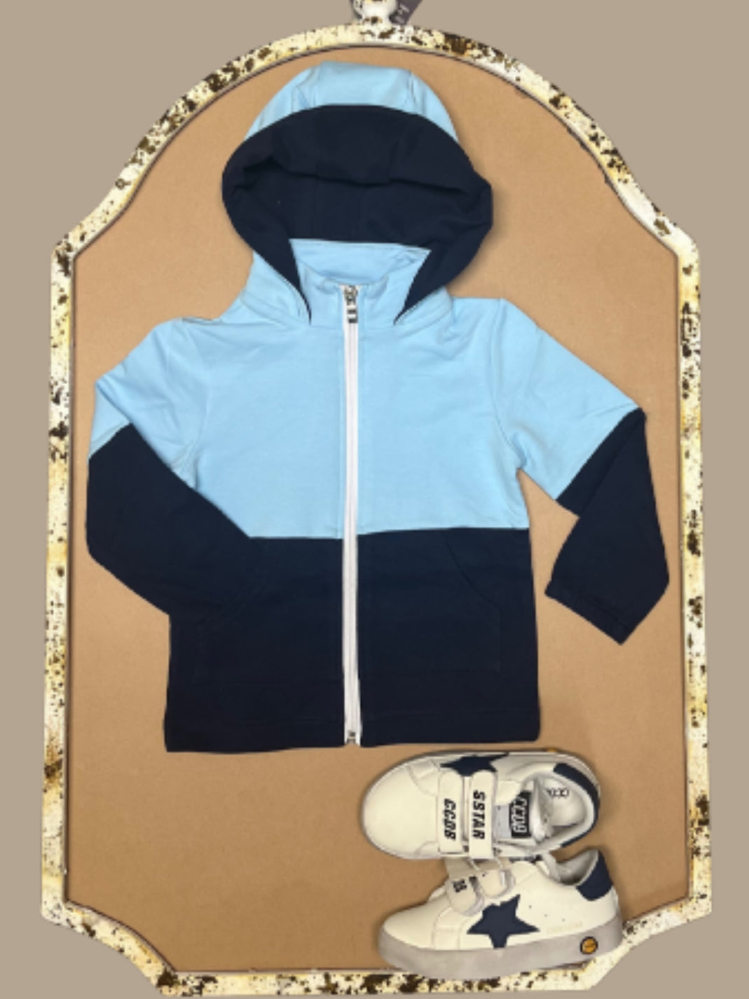 Blue and navy colorblock boys hoodie named “Zayne’s Zip-Up” displayed with white sneakers featuring navy stars from Southern Belle & Beaus.