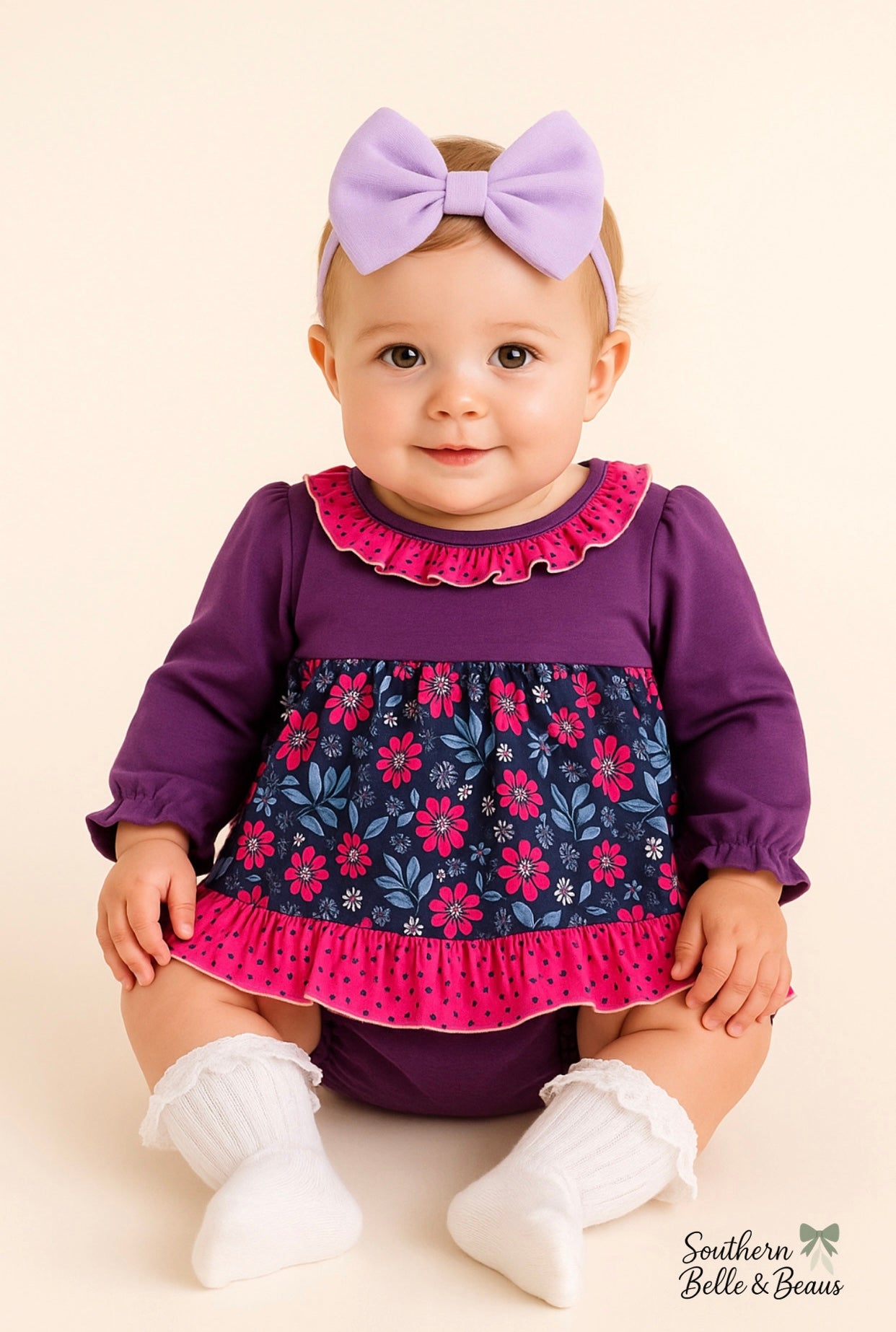 Baby wearing a purple dress with floral skirt and white shoes on a beige background