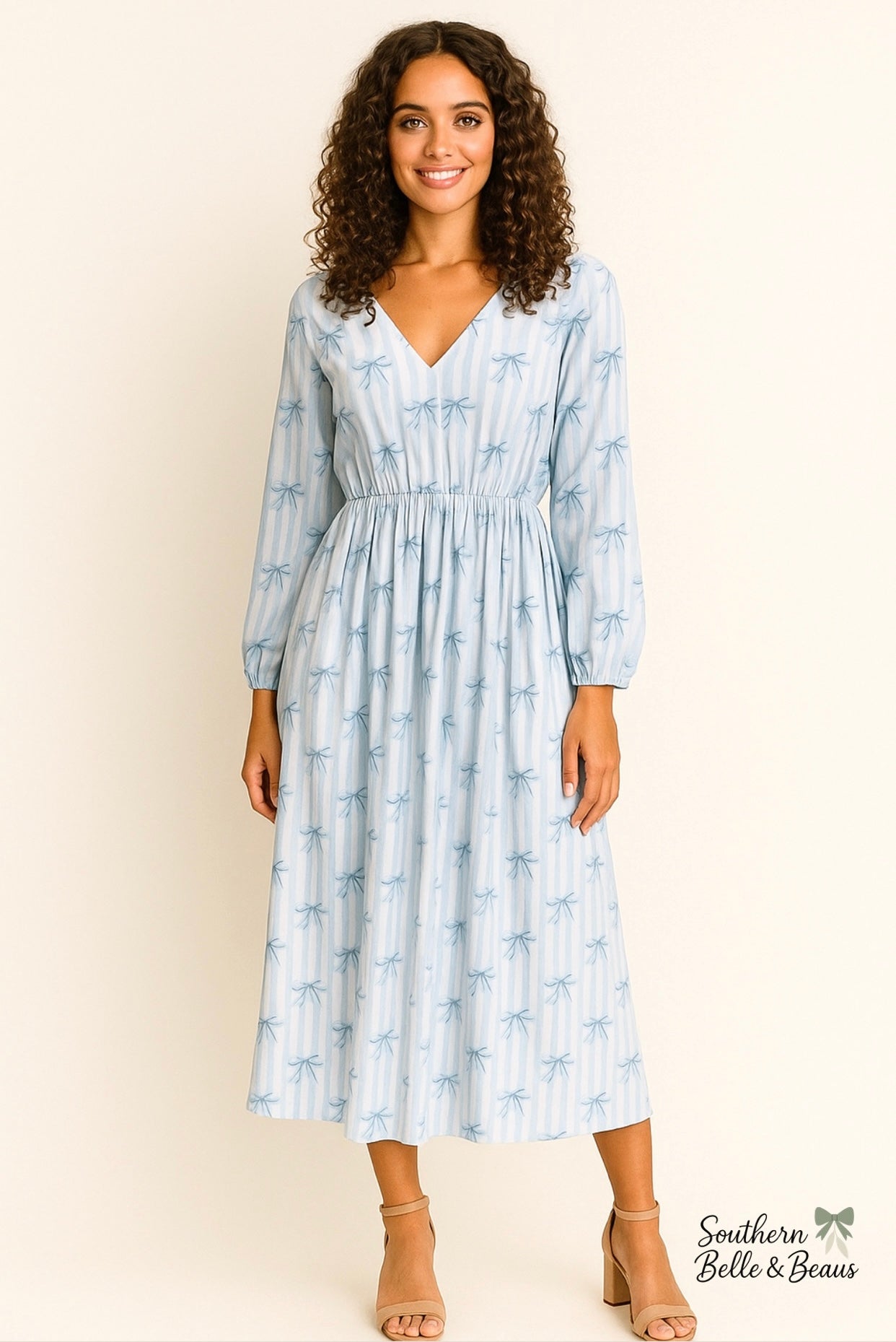 Woman wearing a blue patterned dress against a white background