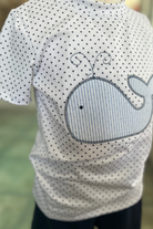 Children's t-shirt with whale design on a blurred background
