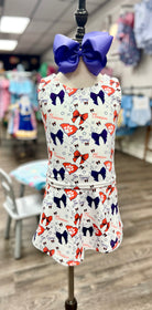 Children's dress with butterfly pattern on a mannequin in a store setting