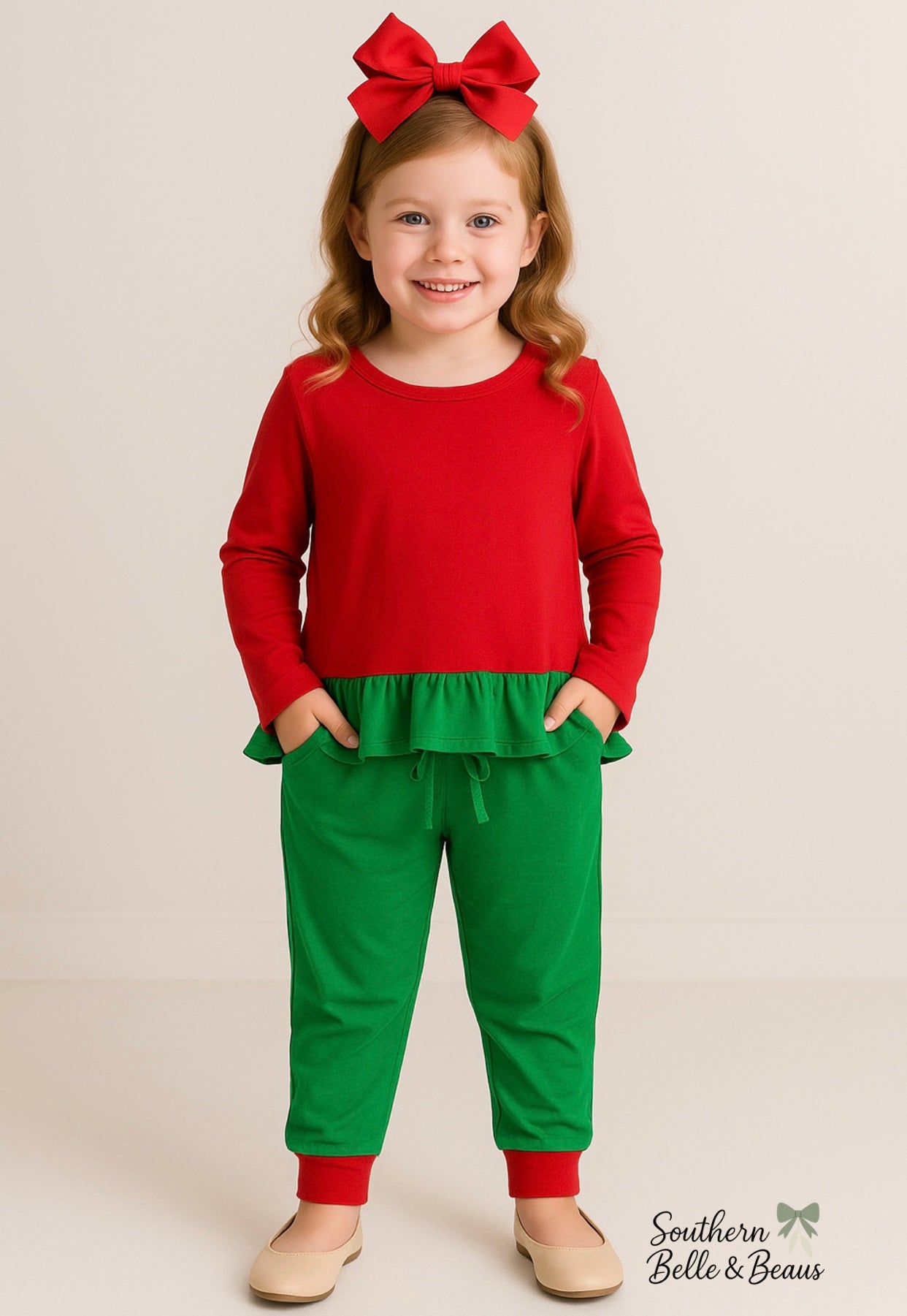 girls’ jogger features a bright red top with a playful green ruffle hem and matching jogger bottoms.