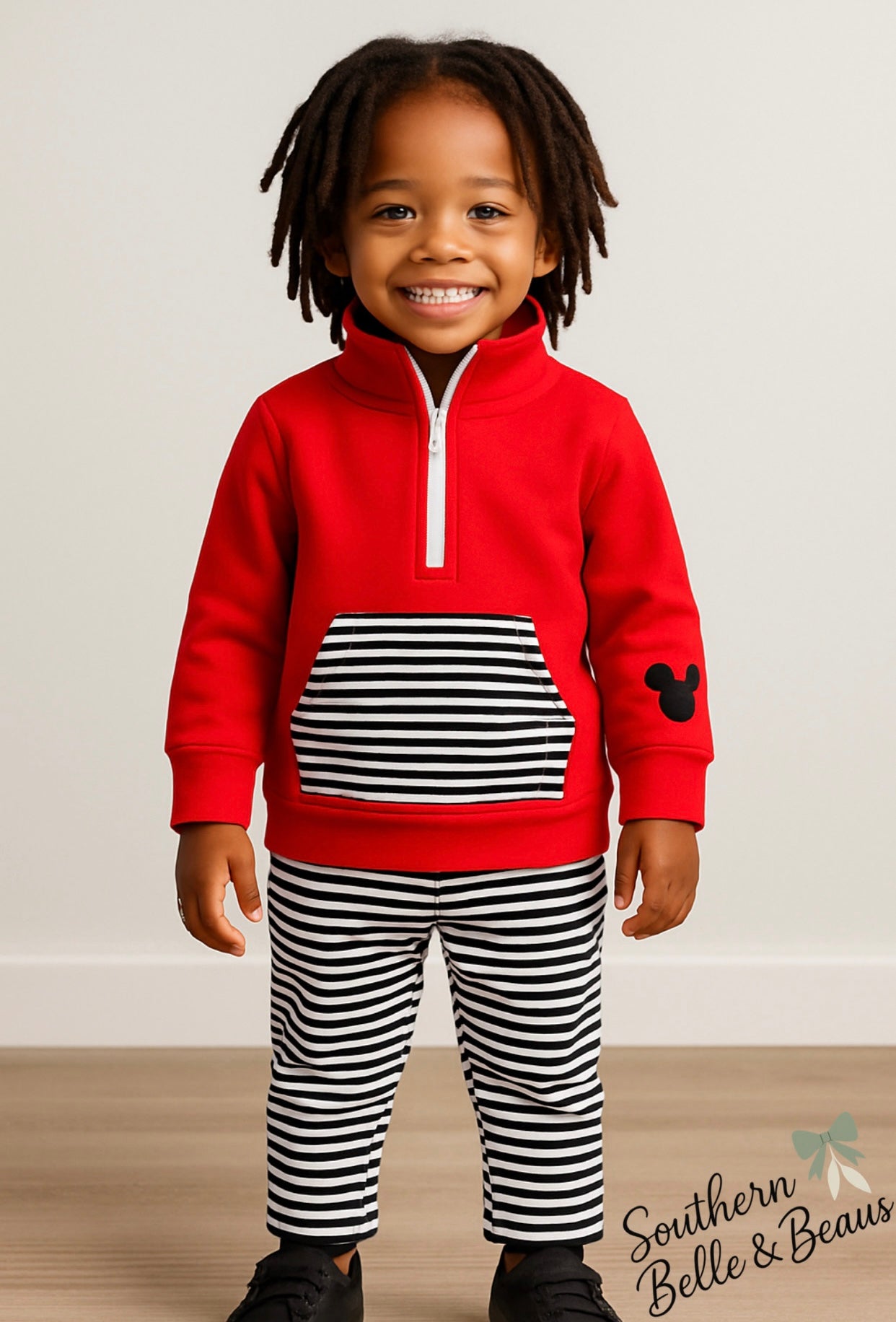 Red pullover with kangaroo striped pocket and striped jogger pants. 