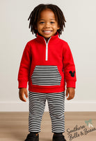 Red pullover with kangaroo striped pocket and striped jogger pants. 