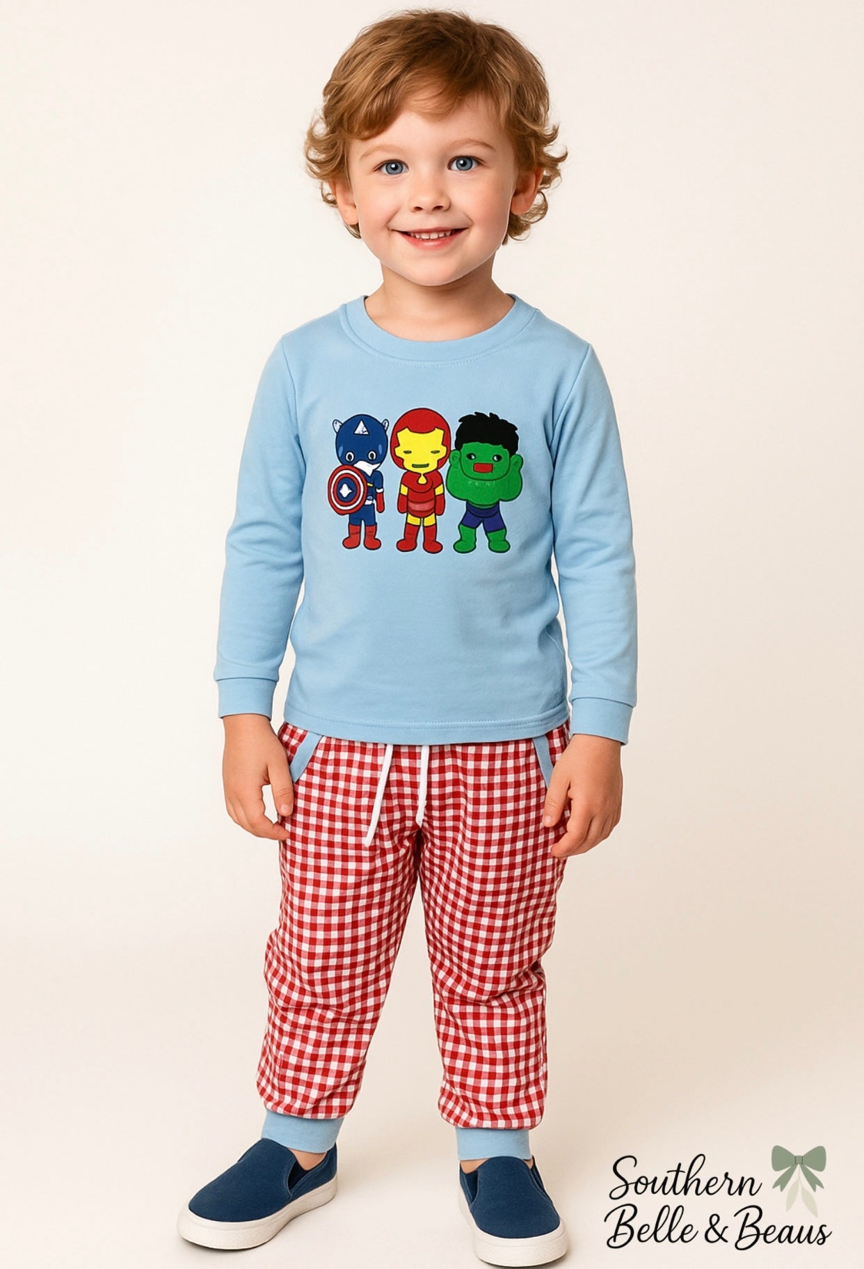Sky-blue long sleeve top with cartoon superheroes and red gingham jogger pants, Hero Hustle Jogger Set.