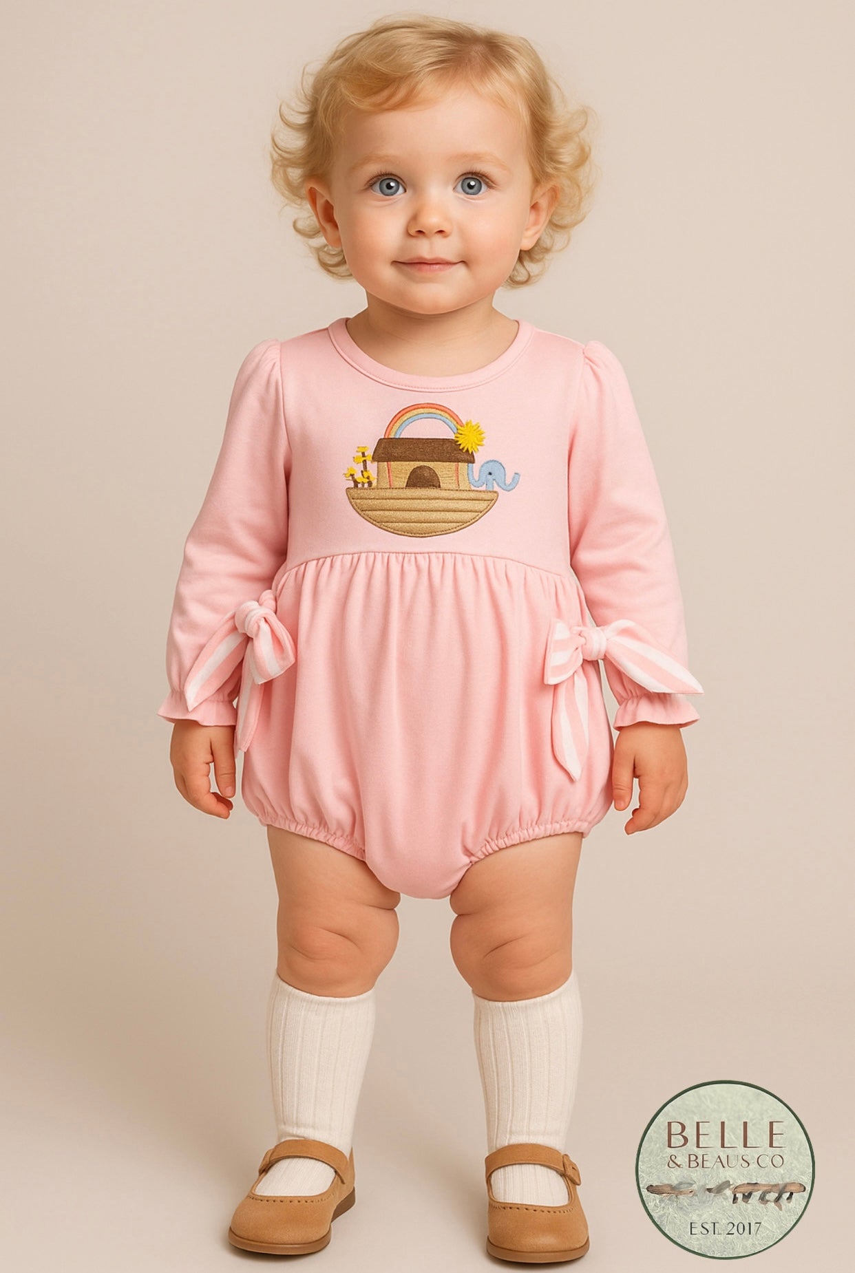 This darling pink bubble features an embroidered Noah’s Ark with sunny details, a rainbow of promise, and the sweetest little animals