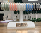 Display stand with various bracelets on tags in a store setting