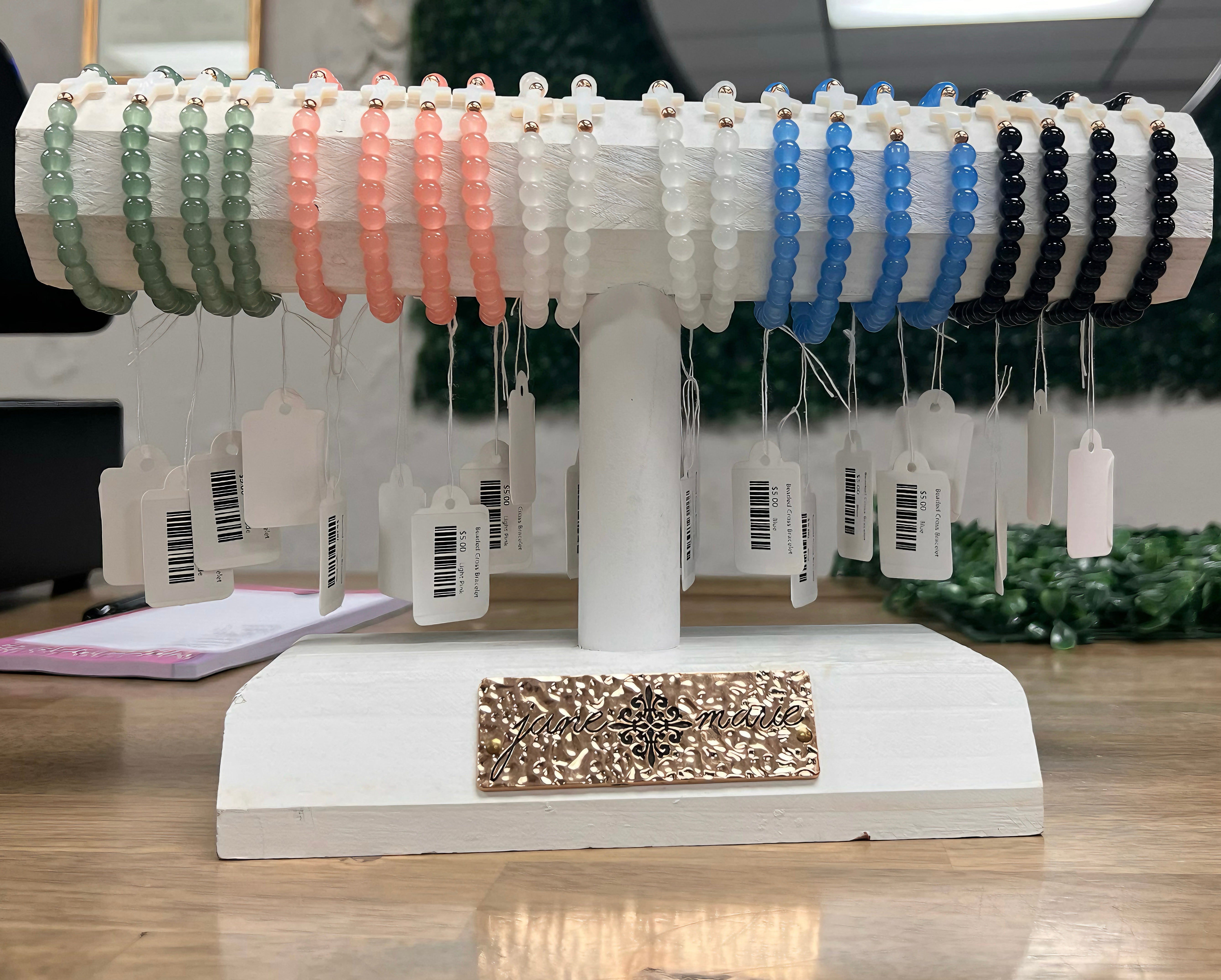 Display stand with various bracelets on tags in a store setting