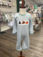 Striped onesie with embroidered design on a mannequin in a store setting