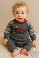 Sweater romper for baby boy, grey with train carrying a present, snowflake sleeves.