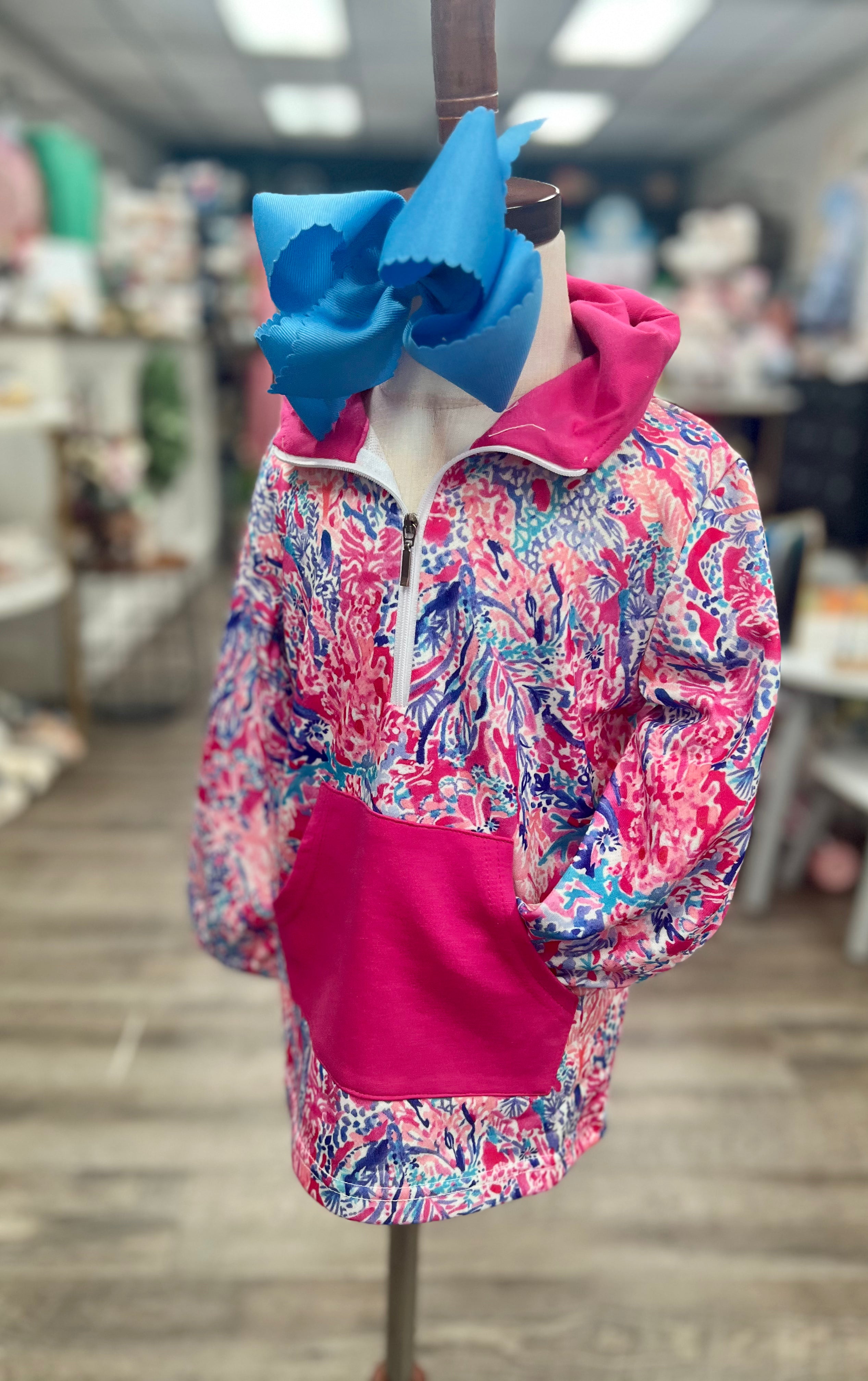 Colorful jacket with pink interior on a mannequin in a store setting