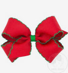 Red bow with green edge on a white background