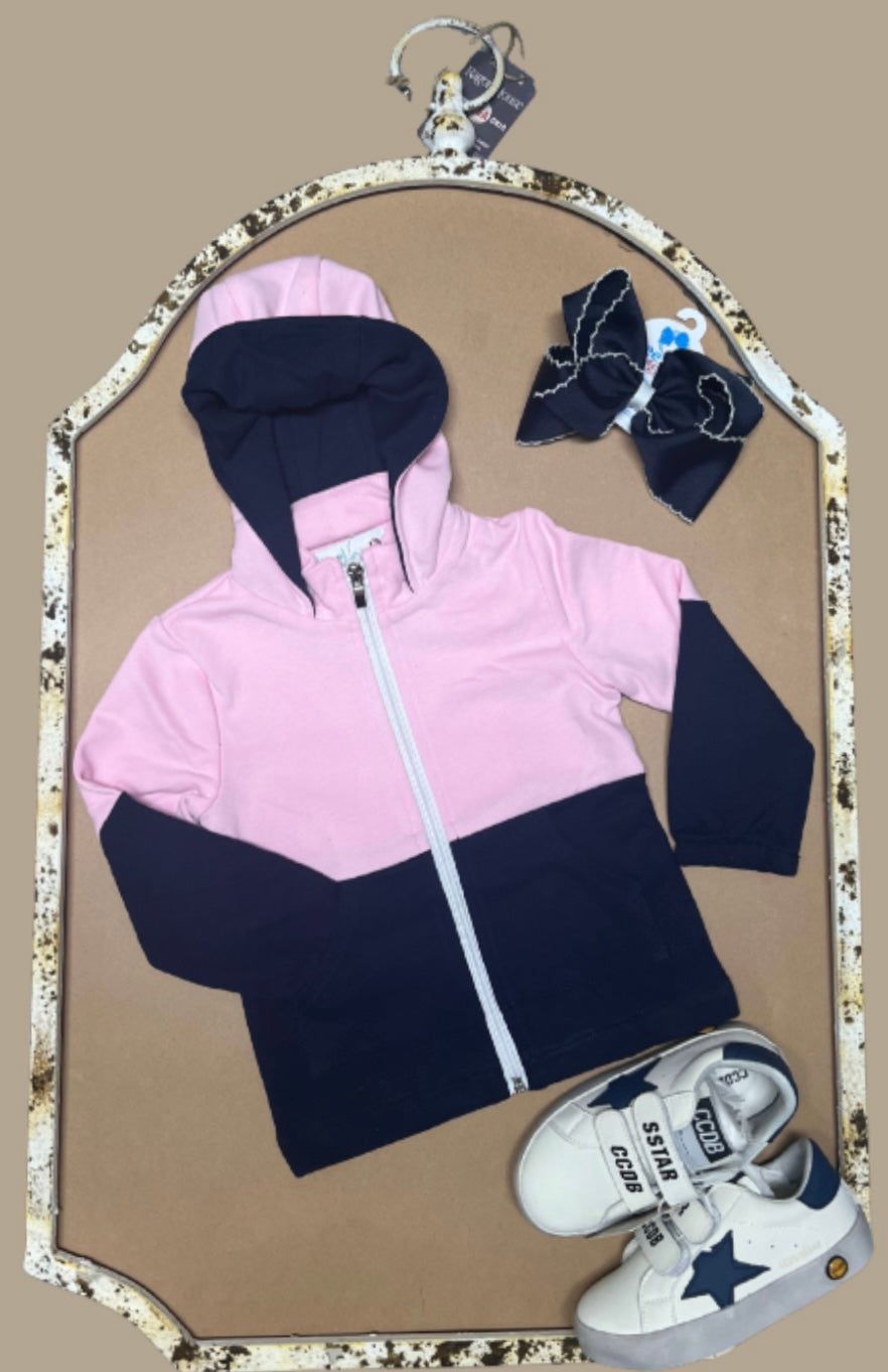 Pink and navy colorblock girls hoodie named “Zuri’s Zip-Up” displayed with matching navy bow and white sneakers from Southern Belle & Beaus.
