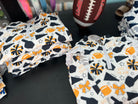 Fabric with sports-themed patterns on a dark surface