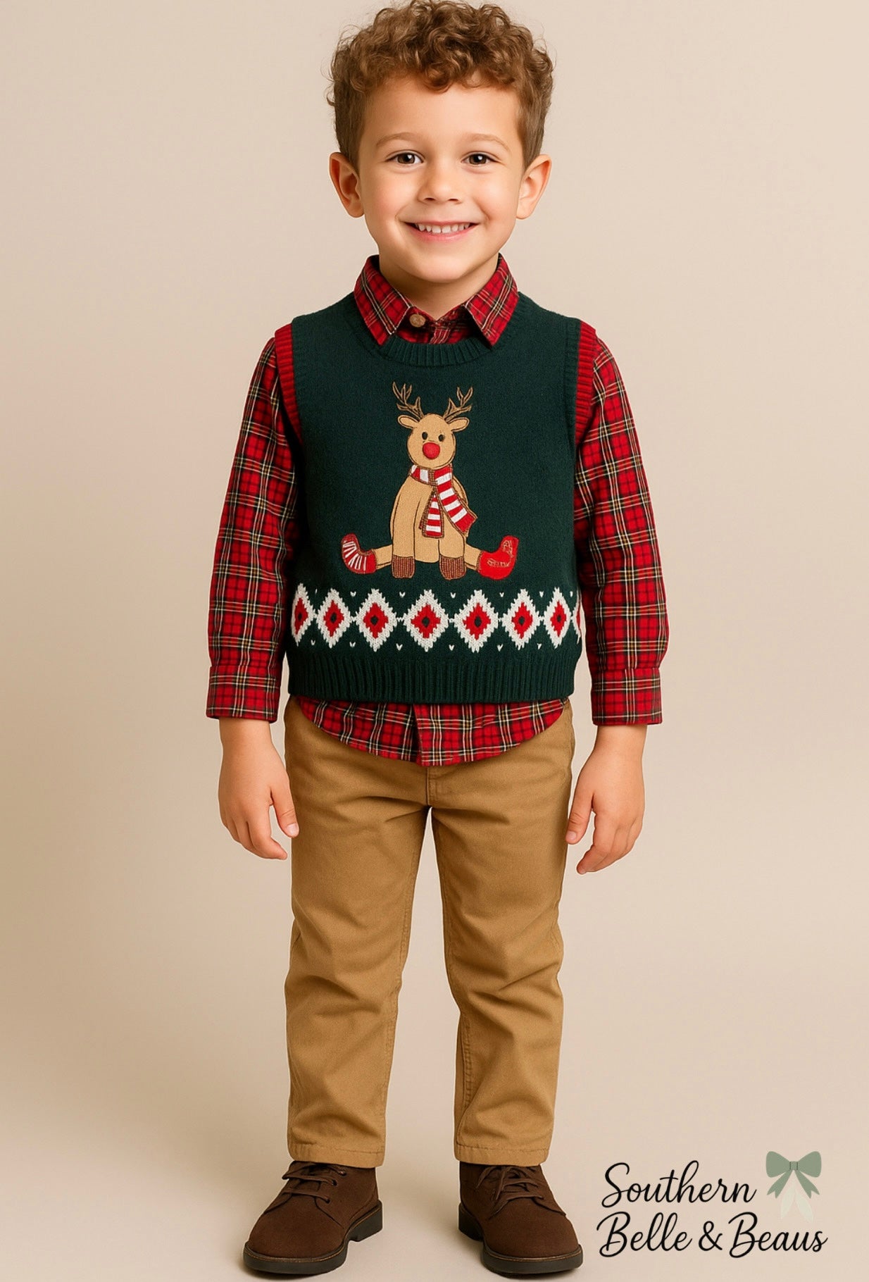 Children's outfit with green sweater vest featuring a reindeer design, plaid shirt, and beige pants.