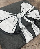 grey t-shirt with white bow outlined in black with game time written on the side of the bow