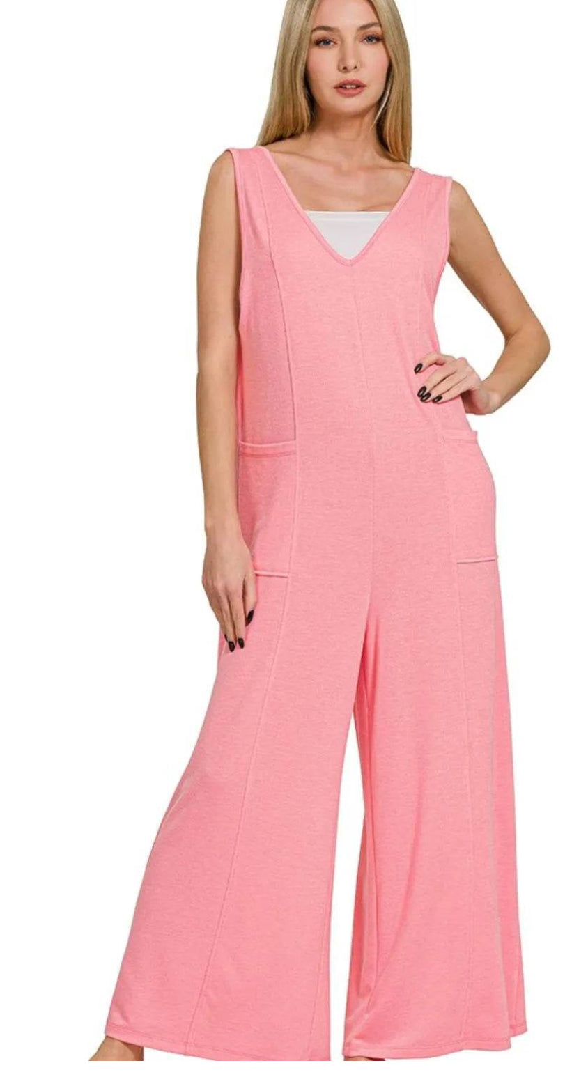 Woman wearing a pink jumpsuit on a white background