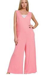 Woman wearing a pink jumpsuit on a white background