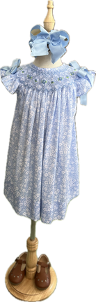 Children's dress with floral pattern on a mannequin