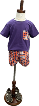Children's outfit with purple shirt and checkered shorts on a mannequin with a white background