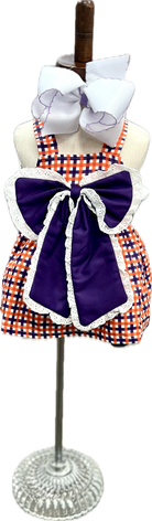 Checkered dress with purple accents on a mannequin against a white background