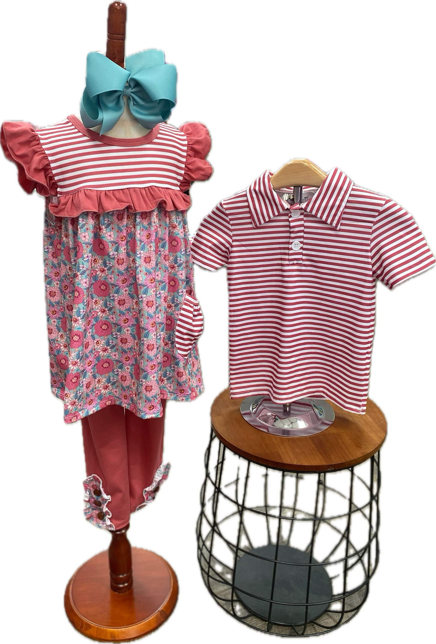 Children's outfit with floral dress, striped shirt, and blue headband on mannequin and stool.