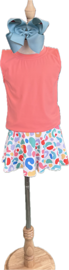 Mannequin wearing a coral sleeveless top and colorful patterned skirt with a blue headband.