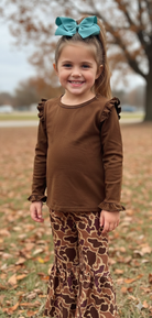 Girl in a brown shirt and flare camo athletic pants
