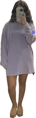 Person wearing a light purple oversized sweatshirt dress on a white background