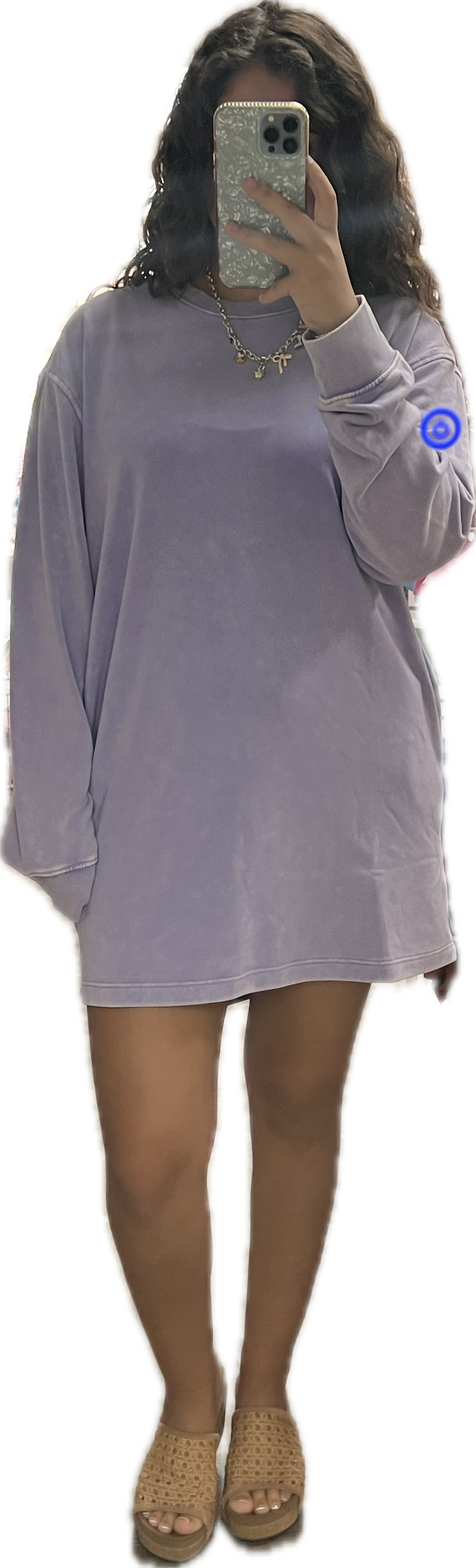 Person wearing a light purple oversized sweatshirt dress on a white background