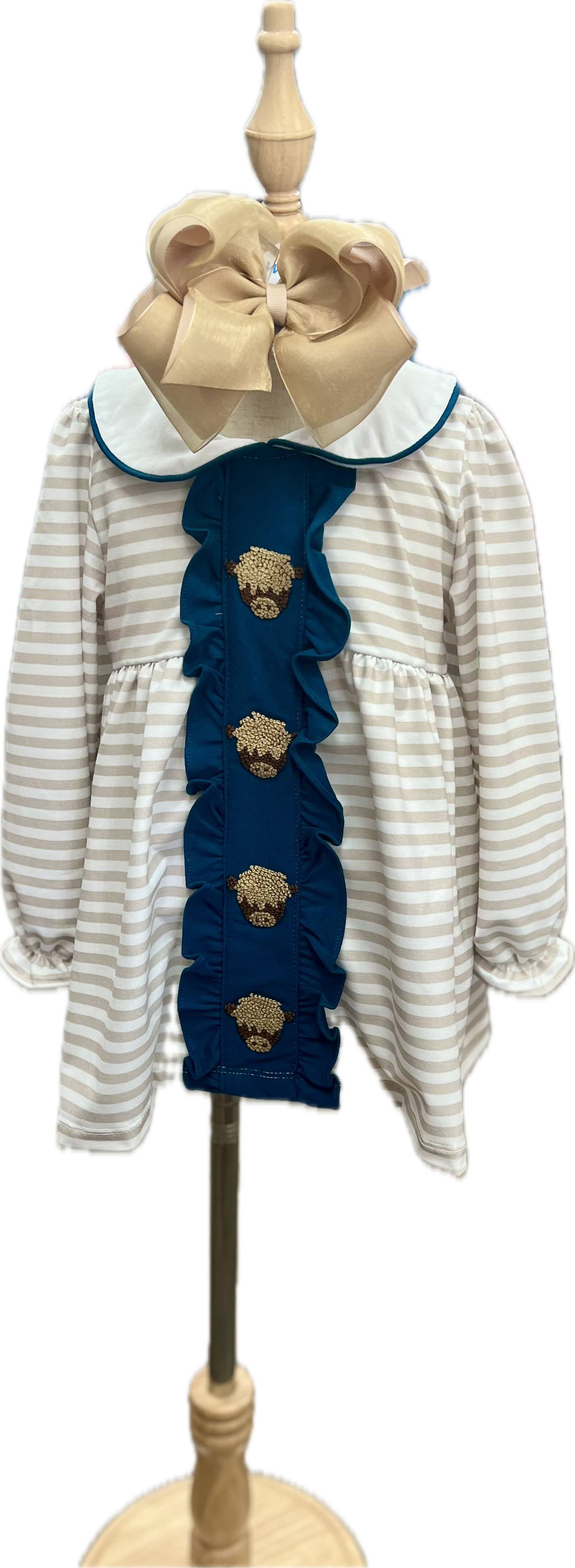 Children's outfit with striped dress and blue ruffled top on a mannequin against a white background