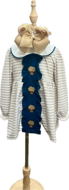 Children's outfit with striped dress and blue ruffled top on a mannequin against a white background