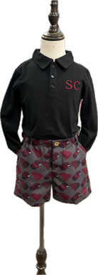 Black polo shirt with 'SC' logo and patterned shorts on a mannequin.