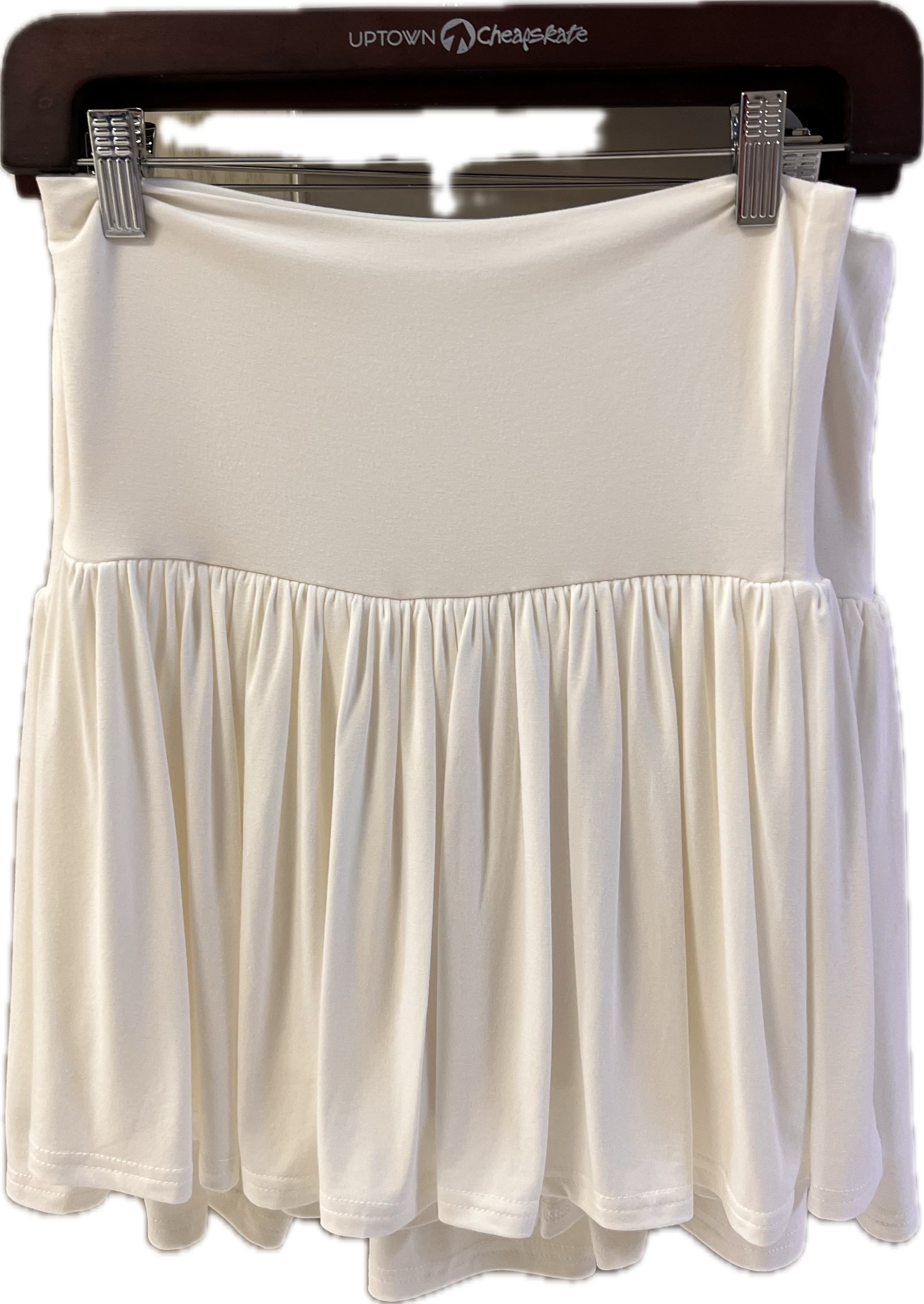 White skirt on a hanger with a visible brand logo.