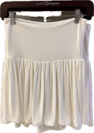 White skirt on a hanger with a visible brand logo.