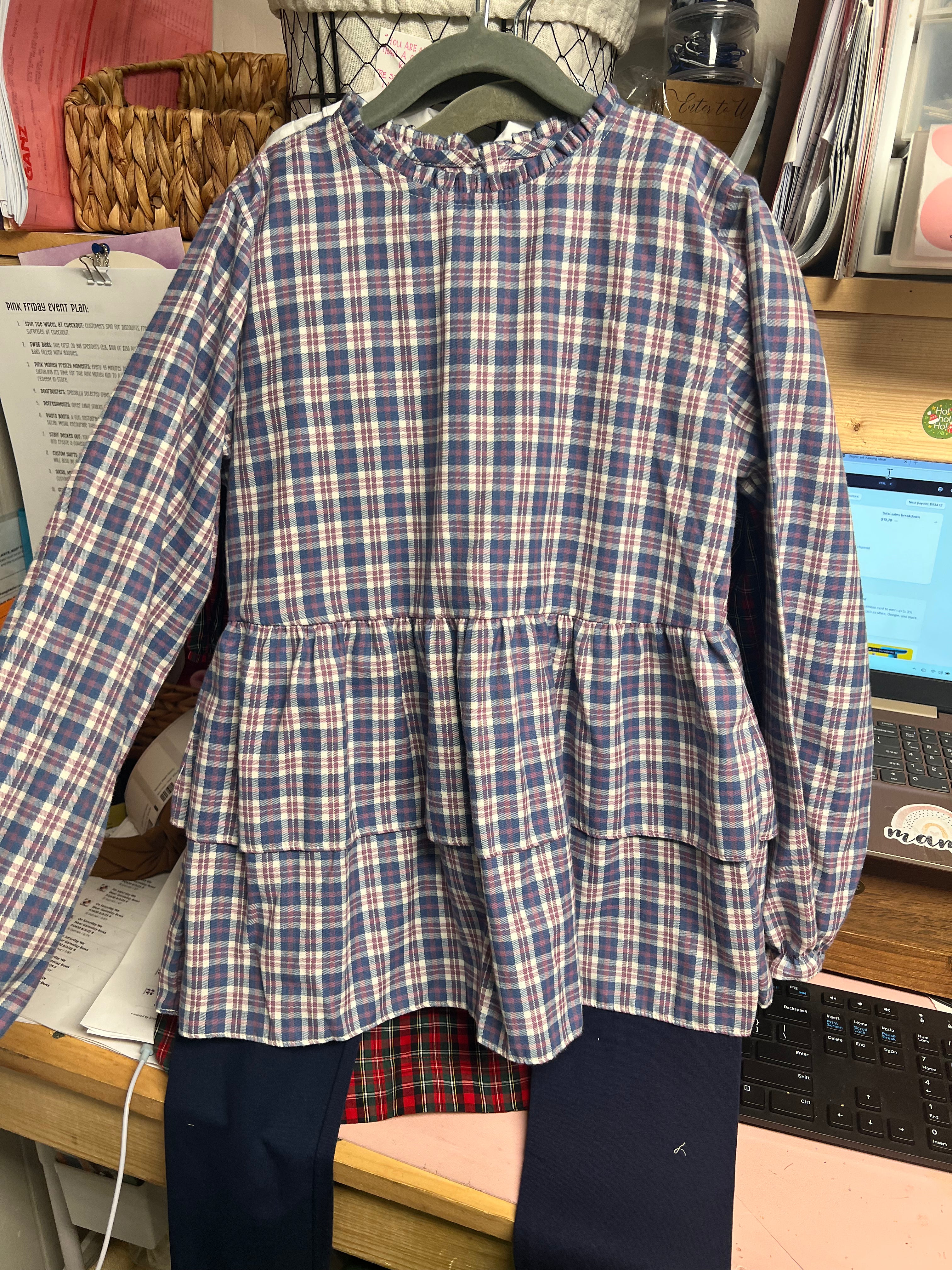 Navy plaid long sleeve smock shirt with navy pants.