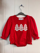 Red baby romper with three Christmas tree appliqués and ruffled cuffs.