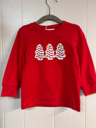 Red long-sleeve boys’ shirt with three white Christmas tree appliqués accented in red and green.